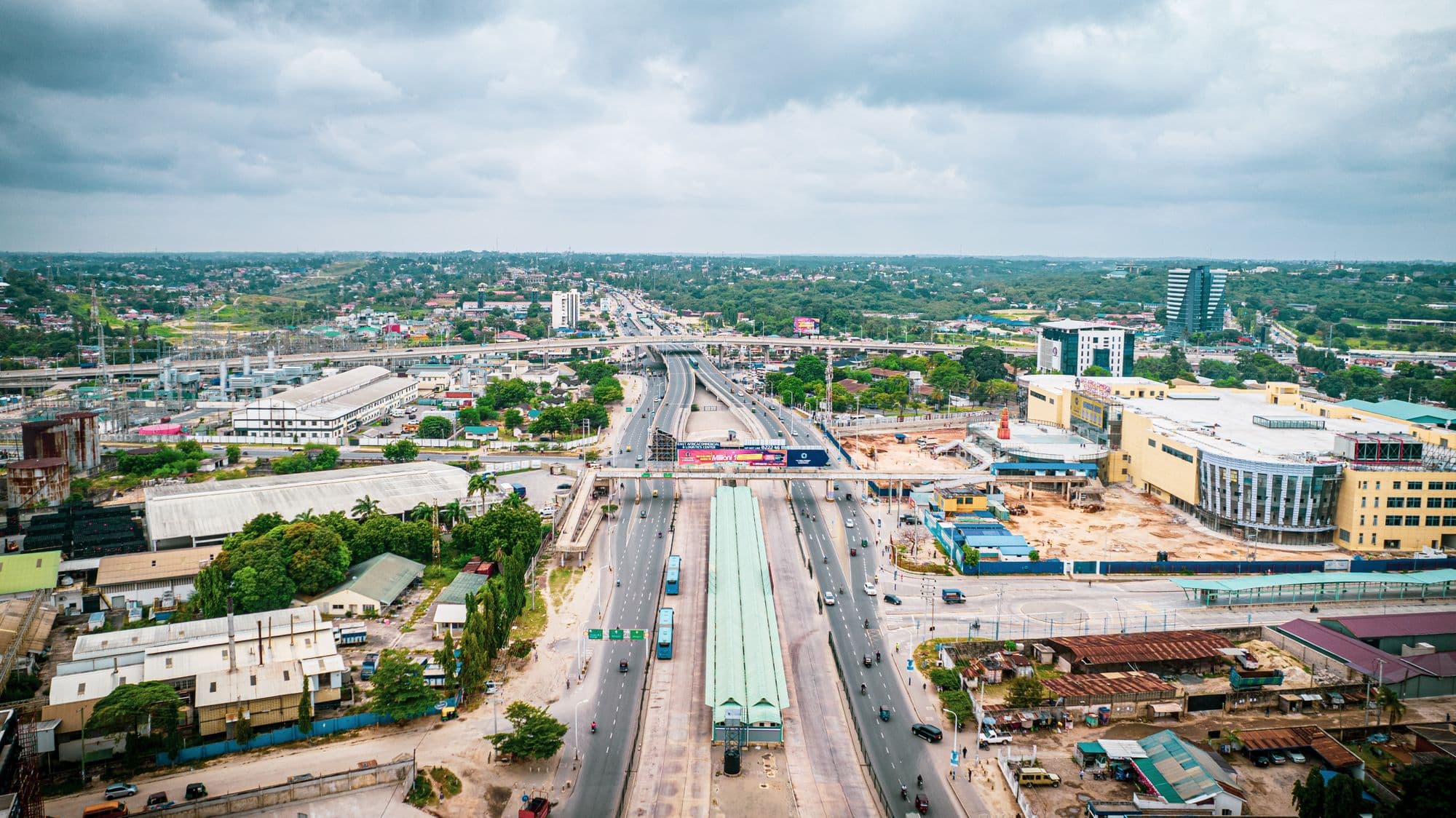 Aerial view of a Dar es Salaam main road with a bus rapid transit station, offices and shops